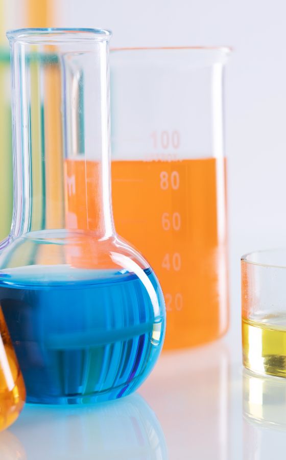 //perspectiwitty.in/kcpl/wp-content/uploads/2024/01/closeup-shot-different-flasks-with-colorful-liquids-white-surface-lab.jpg